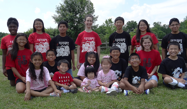 Surrounded by new brothers and sisters who think she is just the greatest little thing