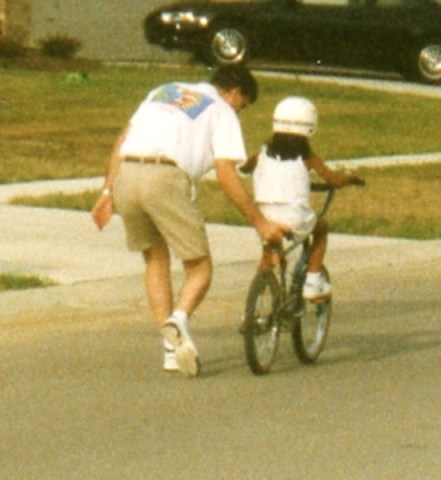 Scott, teaching her to ride a bike